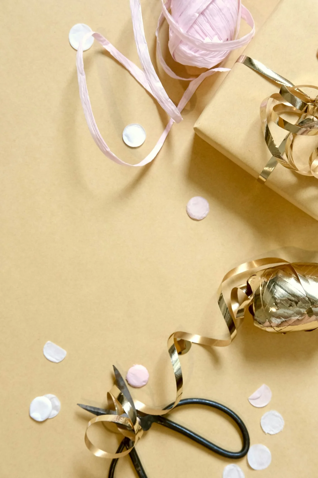 Gift paper and ribbon laid out on a table